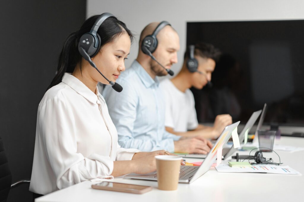 image of a call center with three people waiting to pick up the line